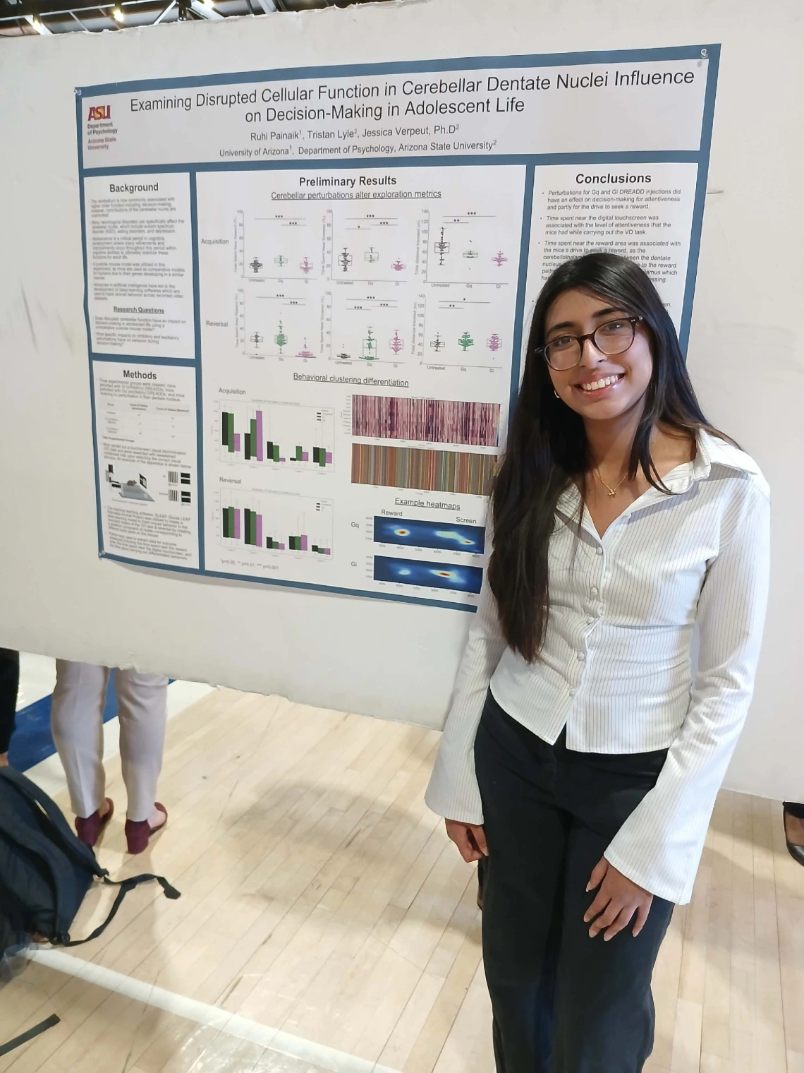Undergraduate student standing next to their Poster Session Board
