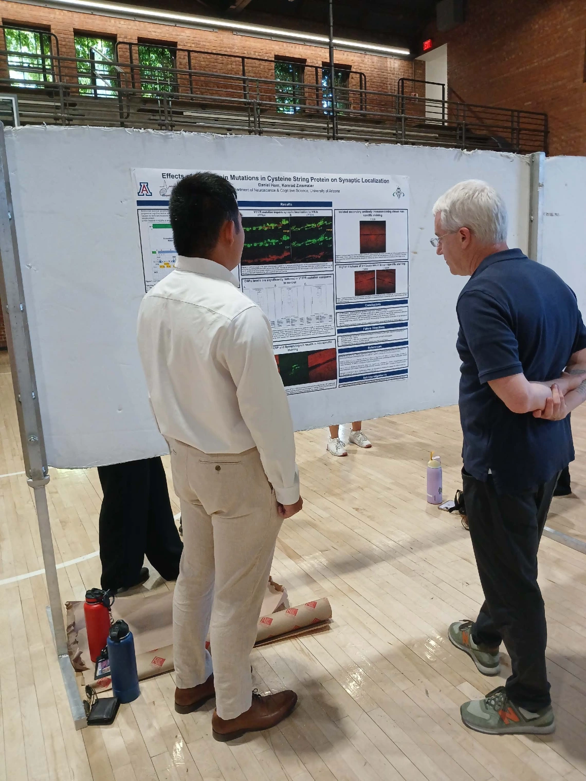 Undergraduate student standing next to their Poster Session Board