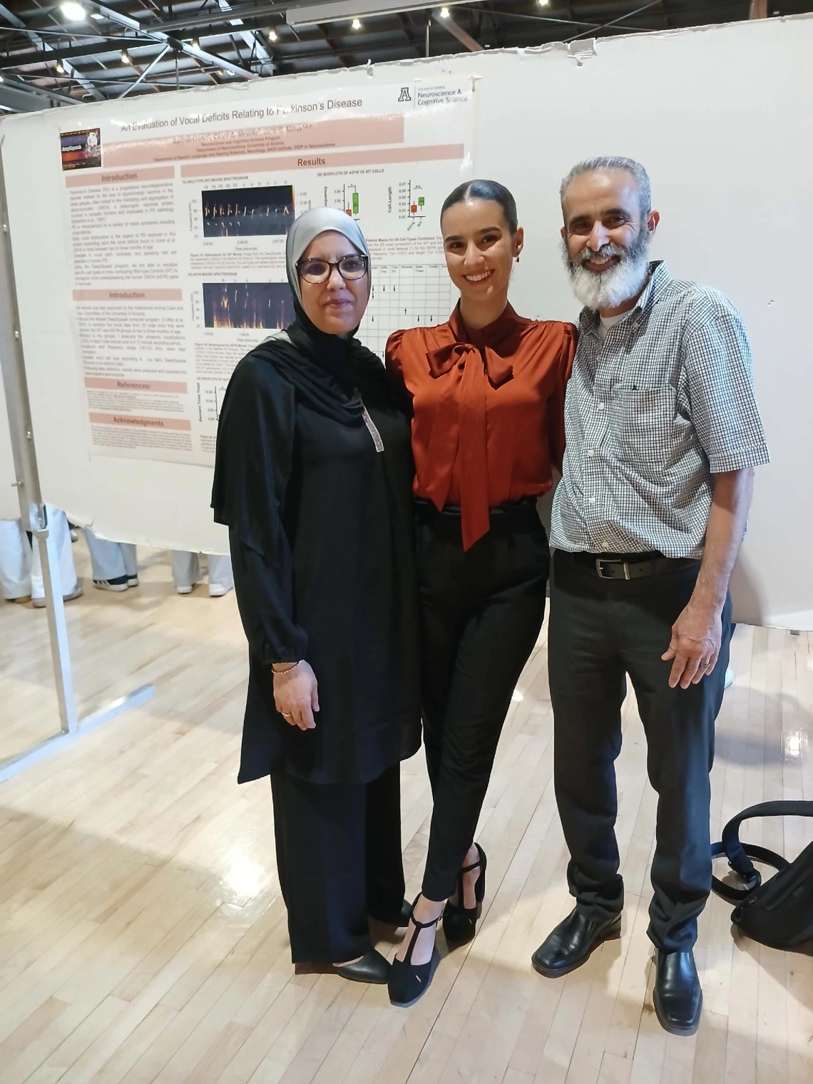 Undergraduate student standing next to their Poster Session Board