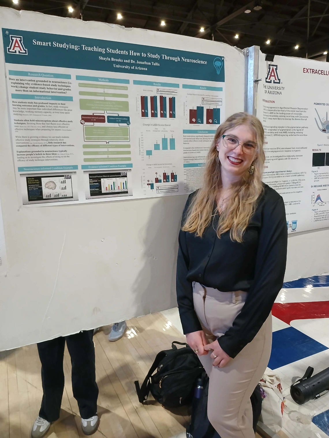 Undergraduate student standing next to their Poster Session Board