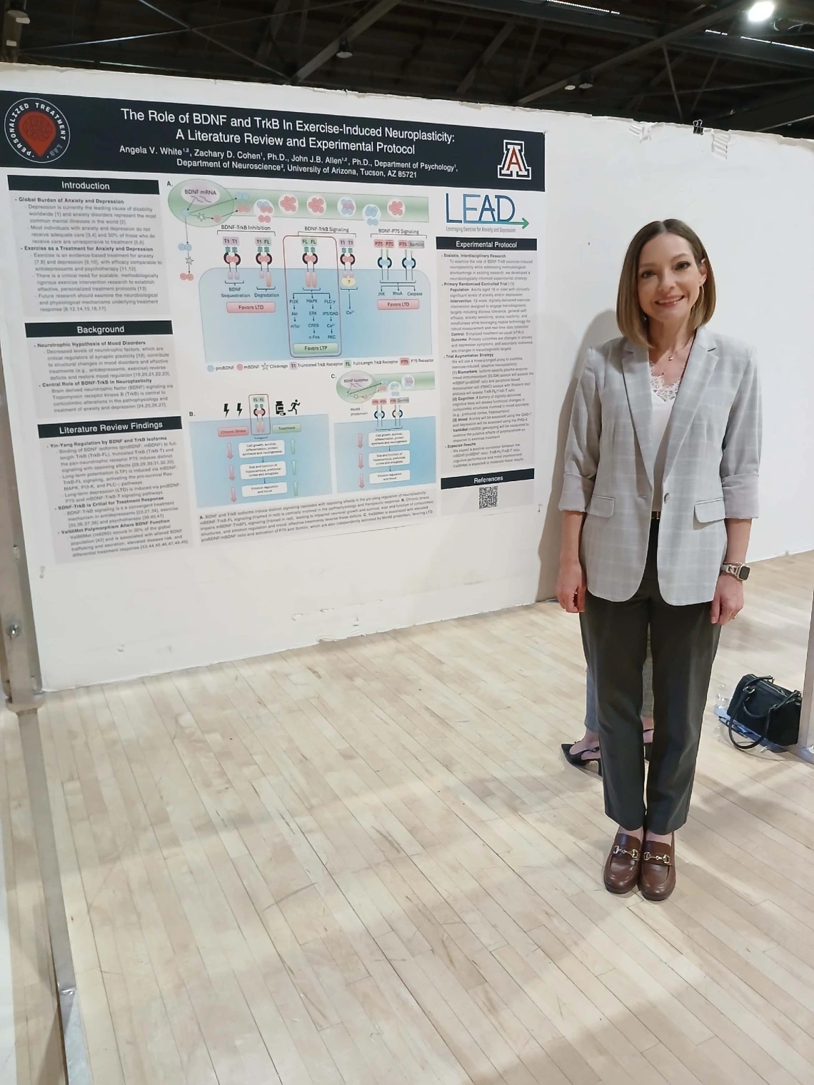 Undergraduate student standing next to their Poster Session Board