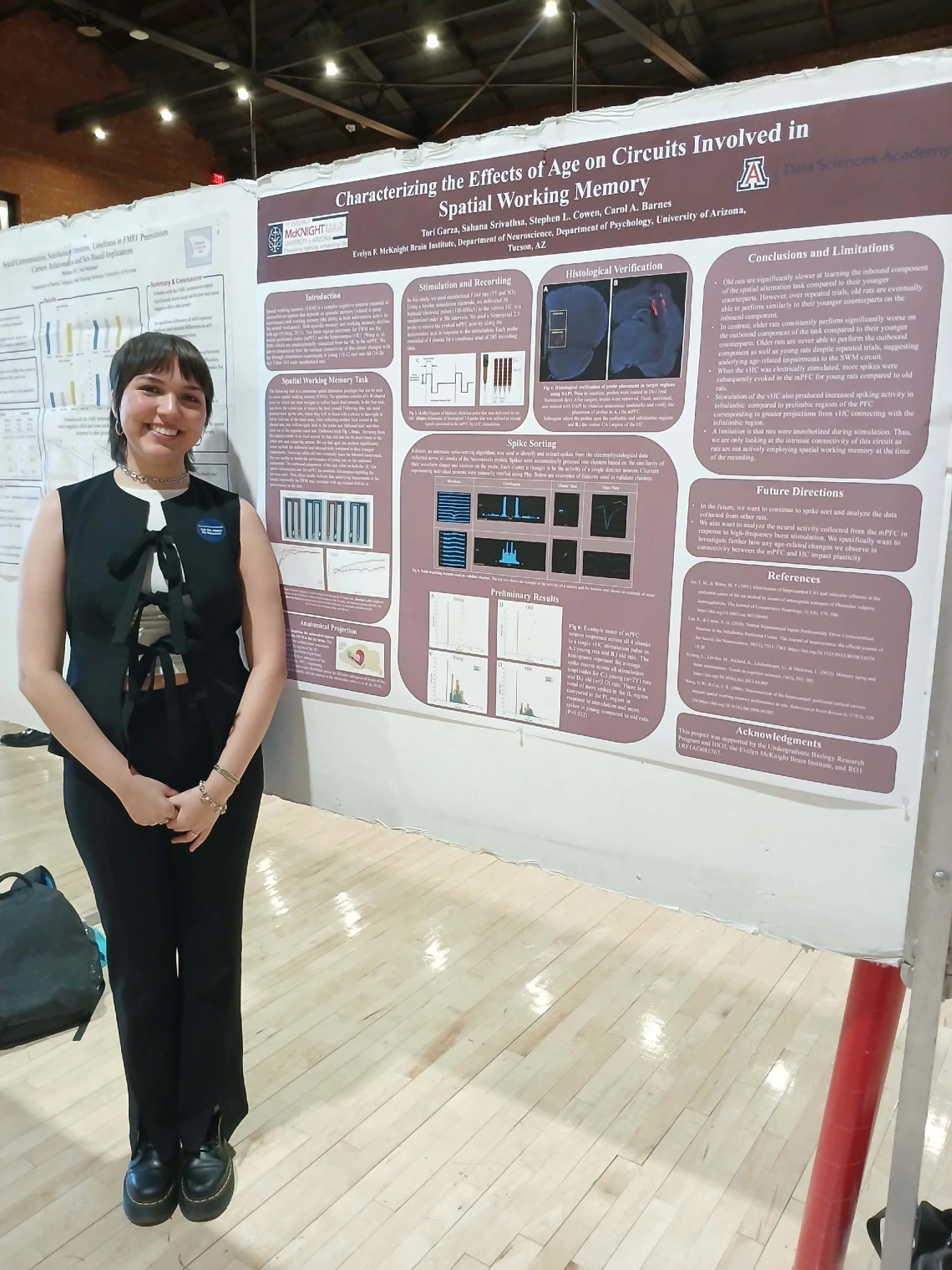 Undergraduate student standing next to their Poster Session Board