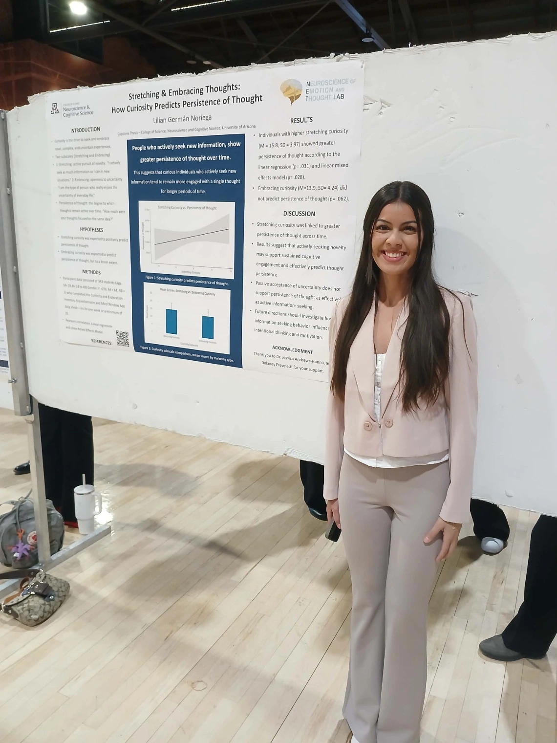 Undergraduate student standing next to their Poster Session Board